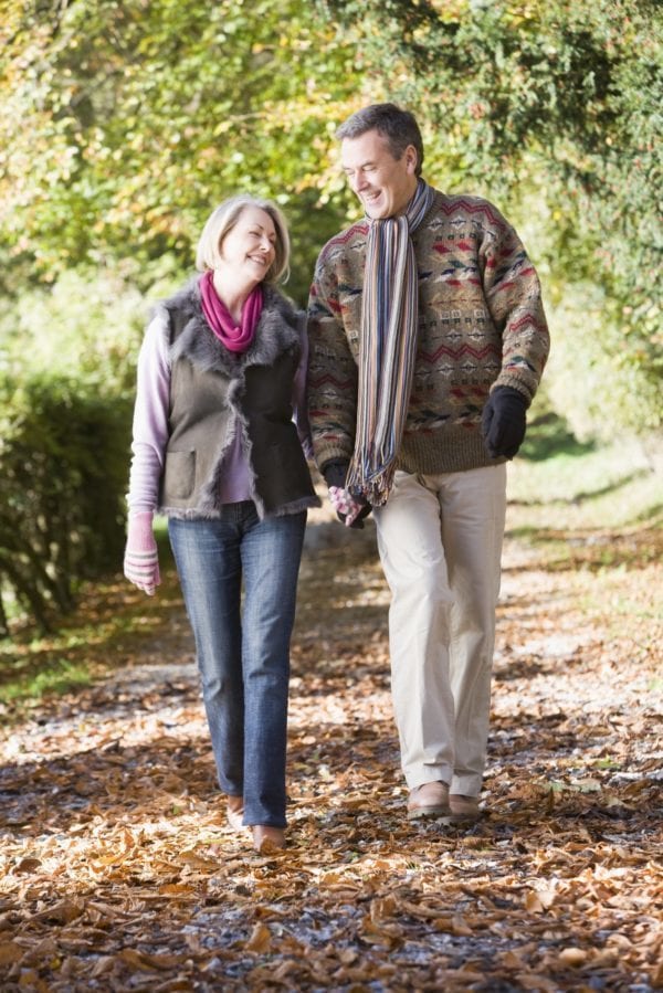 People walking through autumn forest